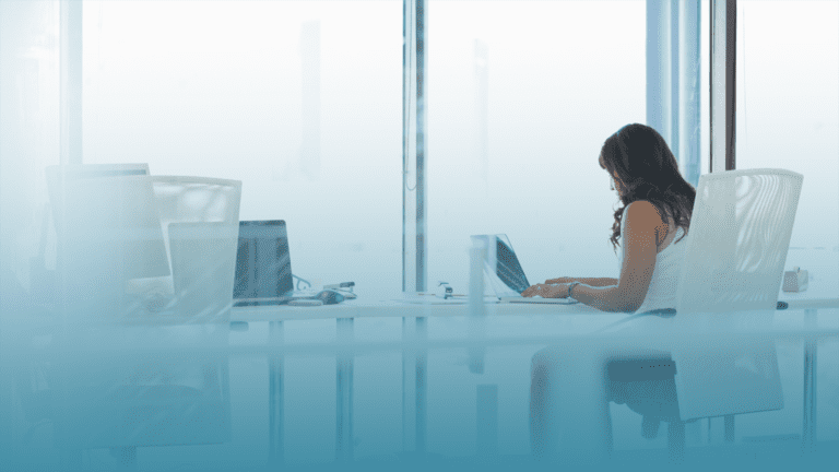 HR Executive sits at her desk learning the differences between Absenteeism vs Presenteeism