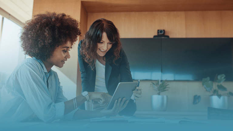 two women sit around a tablet learning about personalized mental health support and why customizable benefits are the future of workforce wellness