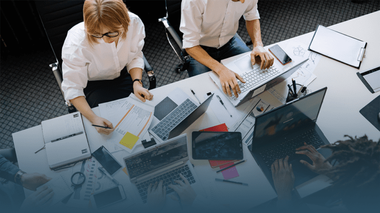 coworkers sit at a table learning about the future of workforce wellness and five trends shaping employee health in 2025