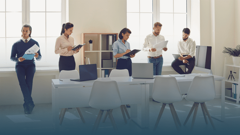 coworkers stand in a conference room reflecting on 2024