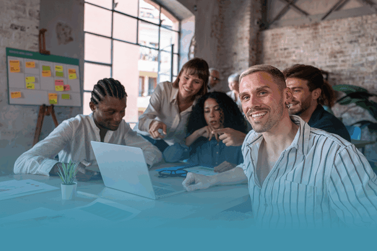 a group of smiling people in an office demonstrating what diversity in the workforce really looks like