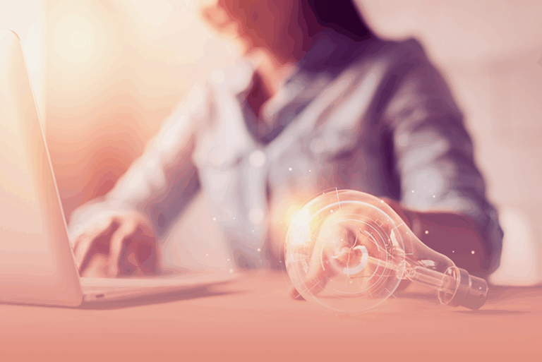 woman taps lightbulb to demonstrate how to encourage innovative thinking at work.