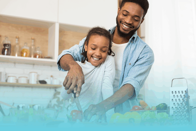 a father and daughter cook together in the kitchen building healthy routines for lasting well-being
