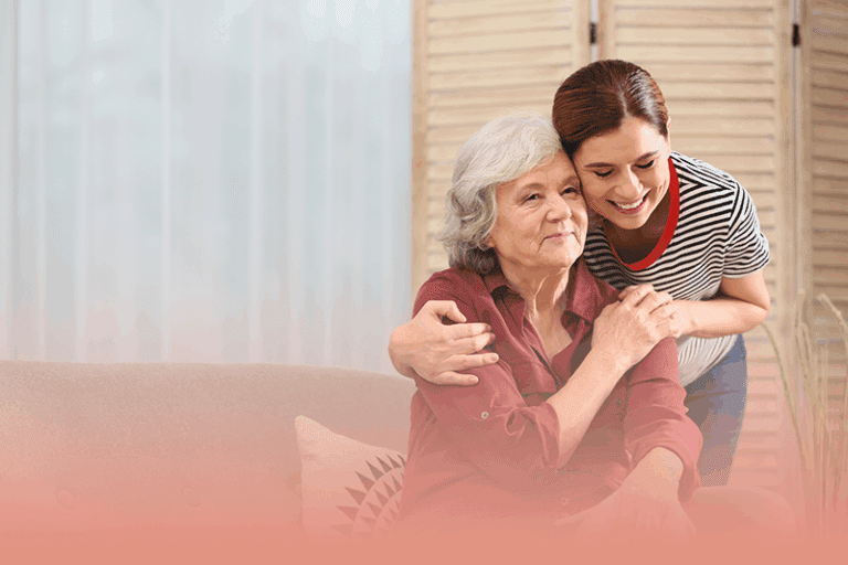 caregiver hugs aging adult as they celebrate national observances in November for supporting caregivers.