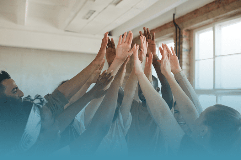 group of diverse people raising their hands together showing how a stigma broke can move the needle on mental health attitude