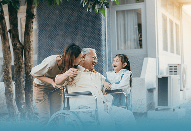 middle-age woman in the sandwich generation laughs with aging father and young daughter